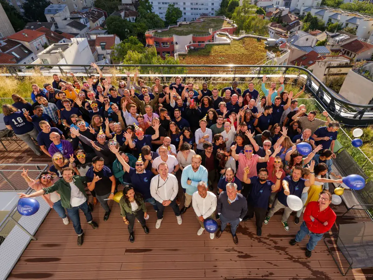 Centreon's team gathered on a rooftop terrace in Paris, waving at the camera